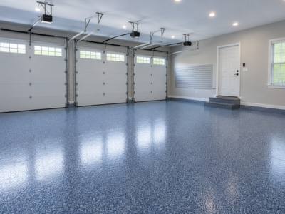 Deep blue chip floor laid across all three bays of a garage