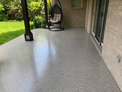 Covered outdoor slab coated and sealed to the edge