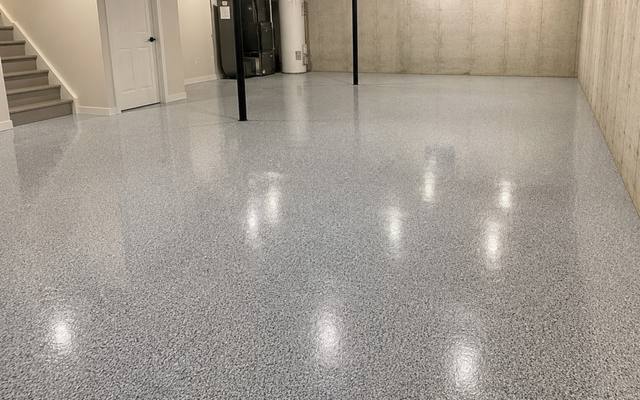 Coated basement slab running past the furnace and water heater