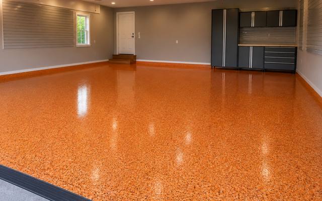 Orange flake broadcast finished across a double bay garage floor
